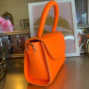 Beautiful bright orange small bag never been worn handbag .